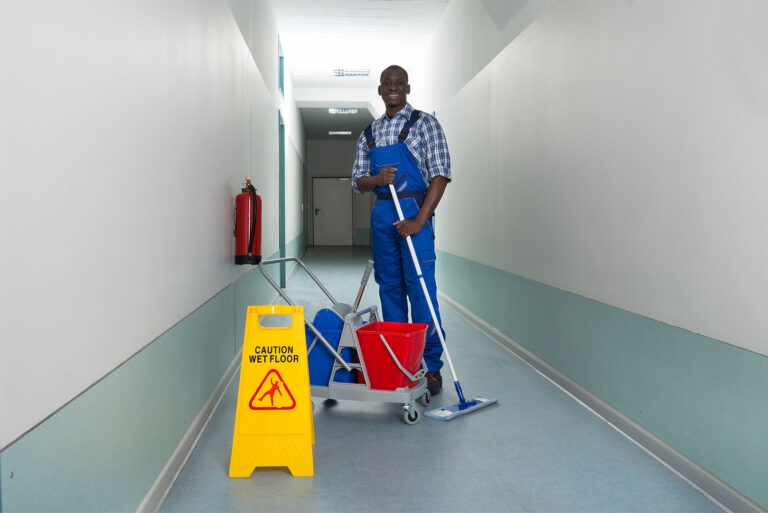 Cleaning technician maintaining a corridor floor